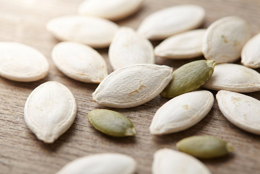 Whole pumpkin seeds and green kernels
